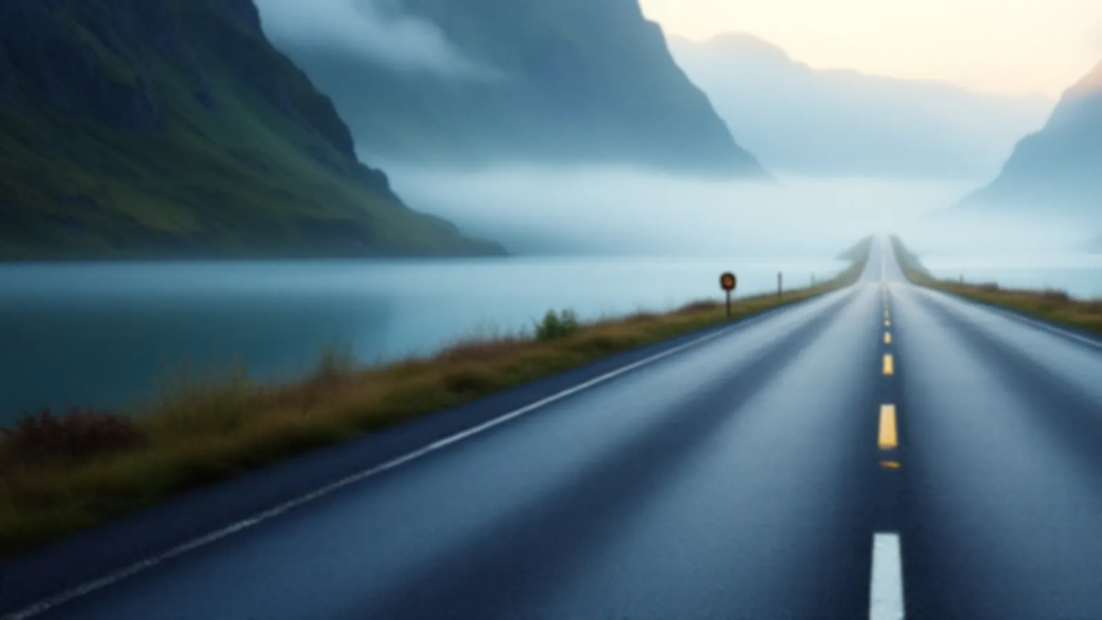An empty road along a calm fjord with steep green walls and soft mist at dawn, the CoupeRate view of personal loan rates online, $100 – $5,000
